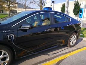 A Chevrolet Volt is plugged into a charging station.