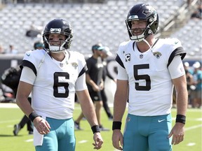 Jacksonville Jaguars quarterbacks Cody Kessler (left) and Blake Bortles talk during warm-ups before a Sept. 23, 2018 National Football League game against the Tennessee Titans in Jacksonville, Fla.