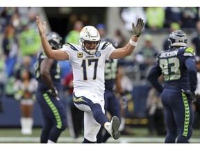 Los Angeles Chargers quarterback Philip Rivers celebrates a touchdown by the team against the Seattle Seahawks during the first half of an NFL football game, Sunday, Nov. 4, 2018, in Seattle.