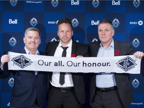 Vancouver Whitecaps new head coach Marc Dos Santos, centre, poses with Whitecaps co-owner Jeff Mallett, left, and team president Bob Lenarduzzi following a news conference in Vancouver on Wednesday, Nov. 7, 2018.