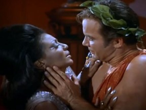 Captain James T. Kirk (William Shatner) and Lieutenant Nyota Uhura (Nichelle Nichols) kiss each other in a scene on "Star Trek." (Paramount Television screengrab)