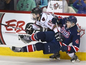 Former Calgary Hitmen Tristen Nielsen, now with the Vancouver Giants, levels Connor Hobbs of the Regina Pats during WHL playoff action last March.