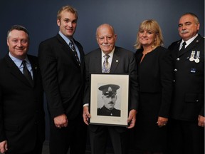 Four generations of Vancouver police officers are, from left, Rick Stewart, Dave Stewart, Bob Stewart Sr., Bob Stewart Jr. and Linda Stewart, in Vancouver on Sept. 22, 2011. Bob Stewart Sr. is holding a 1929 portrait of his father, Arthur Stewart, who is the great-grandfather to Dave. David Stewart was found guilty of misconduct and deceit for his actions during an incident while off-duty in Downtown Vancouver in 2014.