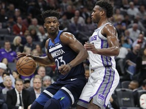 Timberwolves guard Jimmy Butler (23) battles for position against Kings guard Buddy Hield (24) during the first half of an NBA game in Sacramento, Calif., Friday, Nov. 9, 2018.