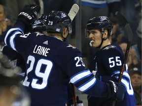 Winnipeg Jets centre Mark Scheifele (right) celebrates his power-play goal against the Washington Capitals in Winnipeg with Patrik Laine on Wed., Nov. 14, 2018. Stopping Scheifele, Laine and the Jets' power play will be key for the Canucks.