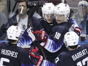 Jack Hughes, Mikey Anderson, Oliver Wahlstrom and Evan Barratt of Team United States celebrate a goal versus Team Slovakia.