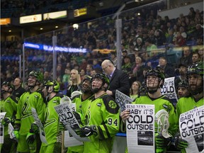 Saskatchewan Rush players hold up signs that showcase the song, Baby It's Cold Outside, during Dec. 8 game at SaskTel Centre in Saskatoon. The Christmas classic is proving too controversial for some radio stations in the wake of the #MeToo movement. The duet —  written in 1944 and performed over the years by scores of artists, including Dean Martin, Dolly Parton, Ray Charles and Lady Gaga — has turned into a hot potato for broadcasters, some of which have yanked the popular song on grounds the lyrics are predatory toward women, although polls show most people support the song.