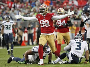 FILE - In this Sunday, Dec. 16, 2018, file photo, San Francisco 49ers defensive end DeForest Buckner (99) celebrates after sacking Seattle Seahawks quarterback Russell Wilson (3) during the second half of an NFL football game in Santa Clara, Calif.