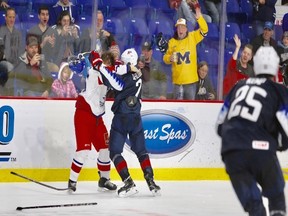 Vancouver Canucks prospect Quinn Hughes of the Americans tussles with Jakub Lauko of the Czech Republic during a world junior exhibition game at the Langley Events Centre on Saturday.