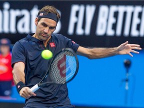 Roger Federer of Switzerland hits a return against Cameron Norrie of Britain during their fourth session men's singles match on day two of the Hopman Cup tennis tournament in Perth on December 30, 2018.