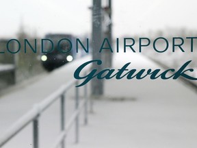 FILE - In this Dec. 1, 2010, file photo, a terminal link train arrives behind a glass window at the snow covered terminal station at London's Gatwick Airport in Horley, England. London's Gatwick Airport shut down late Wednesday, Dec. 19, 2018, while officials urgently investigated reports that two drones were flying above the airfield.