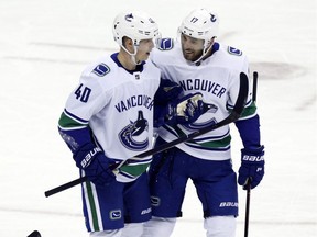 Vancouver Canucks forward Elias Pettersson, left, of Sweden, celebrates his goal against the Columbus Blue Jackets with teammate forward Josh Leivo during the third period of an NHL hockey game in Columbus, Ohio, Tuesday, Dec. 11, 2018. The Canucks won 3-2.