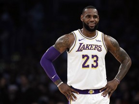 Los Angeles Lakers' LeBron James smiles during a break in action during the first half of an NBA game against the Memphis Grizzlies on Sunday, Dec. 23, 2018, in Los Angeles.