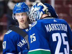Vancouver Canucks' Elias Pettersson, left, and goalie Jacob Markstrom, both of Sweden, celebrate Vancouver's 5-1 win against the Philadelphia Flyers during an NHL hockey game in Vancouver, on Saturday December 15, 2018.