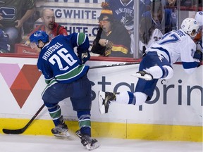 Antoine Roussel of the Vancouver Canucks sent Yanni Gourde flying into the boards on Tuesday. The Tampa Bay Lightning centre felt the presence of the Canuck forward several times during the NHL game at Rogers Arena.