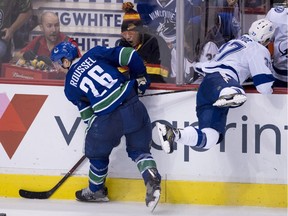 Antoine Roussel hits Yanni Gourde before the pair fought in the second period Tuesday.