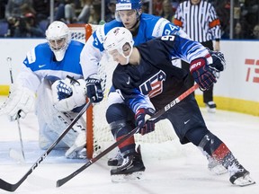 Team USA forward Tyler Madden ries to get a shot on Kazakhstan goalie Vladislav Nurek in the third period during IIHF world junior hockey action in Victoria on Friday.