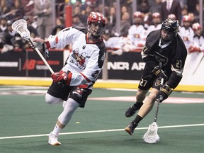 Warriors Owen Barker (right) tries to chase down Calgary Roughnecks Chris Boushy during the inaugural home opener for the Vancouver NLL franchise at Rogers Arena.