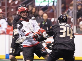 Vancouver Warriors defender Mackenzie Mitchell blocks the shot attempt of Calgary Roughnecks sniper Rhys Duch (during NLL lacrosse action at Rogers Arena Friday. Duch, a former member of the Warriors, had two goals and eight assists in the Calgary win.