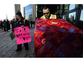 Canada Post rural suburban mail carrier Anita Baric, right, rallies outside Canada Post headquarters prior to Canada Post hosting its Annual Public Meeting in Ottawa on Wednesday, Dec. 12, 2018.