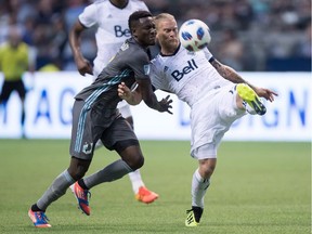 Vancouver Whitecaps' Marcel de Jong (right) and Minnesota United's Abu Danladi vie for the ball during a Major League Soccer game last July at B.C. Place. The clubs will renew their rivalry in the 2019 MLS season opener for both clubs at the same venue.