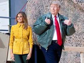 U.S. President Donald Trump and first lady Melania Trump arrive to speak to members of the U.S. military during an unannounced visit to Al Asad Air Base in Iraq on Dec. 26, 2018.