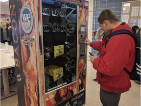 Ohio State University sophomore Nick Vales buying a package of bacon slices from a vending machine available on the Columbus campus on Dec. 7, 2018.