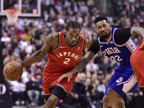 Toronto Raptors forward Kawhi Leonard (2) moves pass Philadelphia 76ers forward Wilson Chandler (22) during first half NBA basketball action in Toronto on Wednesday, Dec. 5, 2018.