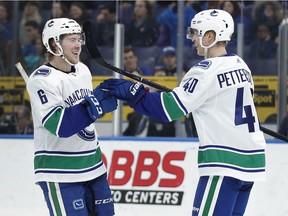 Elias Pettersson shoots to score past St. Louis Blues' Jay Bouwmeester during the first period.