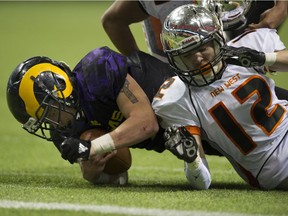 Mount Douglas Rams quarterback Gideone Kremler dives for a first down as New Westminster Hyacks Greyson Planinsic tries to make the tackle during Saturday's Provincial AAA high school football finals on Saturday.