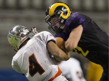 VANCOUVER December 01 2018.   New Westminster Hyacks QB #4 Kinsale Phillip is tackled by Mount Douglas Rams #52 Aiden Bertuzzi in the AAA final of the BC high school football championships at the Subway Bowl 2018, BC Place, Vancouver,  December 01 2018.   Gerry Kahrmann  /  PNG staff photo) 00055454B [PNG Merlin Archive]