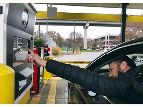 In this Friday, Dec. 7, 2018, photo, a rental car driver demonstrates a new biometric scanning machine by placing his finger on the reader at the Hertz facility at Hartsfield-Jackson Atlanta International Airport, in Atlanta. In a first for the rental car industry, Hertz is teaming up with Clear, the maker of biometric screening kiosks found at many airports and stadiums. Hertz says the partnership will slash the time it takes to pick up a rental car.