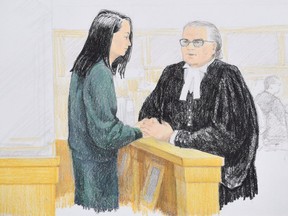 In this courtroom sketch, Meng Wanzhou, left, the chief financial officer of Huawei Technologies speaks to her lawyer David Martin during a bail hearing at B.C. Supreme Court in Vancouver, on Monday, December 10, 2018.