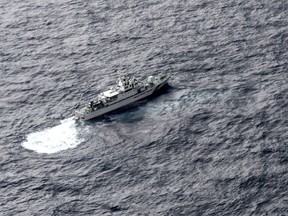 In this aerial photo, Japan's Coast Guard ship is seen at sea during a search operation for U.S. Marine refueling plane and fighter jet off Muroto, Kochi prefecture, southwestern Japan, Thursday, Dec. 6, 2018.