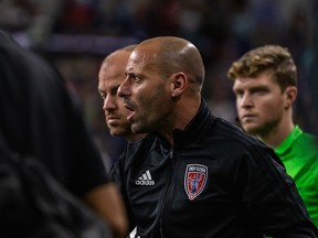 Phillip Dos Santos was hired as an assistant coach by the Vancouver Whitecaps on Friday, where he'll work under his older brother Marc.