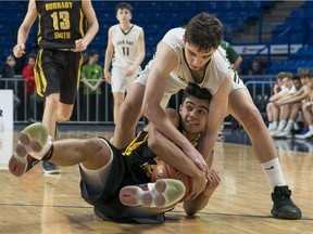 Oak Bay Bays Diego Maffia, right, battles Burnaby South Rebels Jiordano Khan for the loose ball during the quarterfinals of the Quad A B.C. High School Boys Championships at the Langley Events Centre on March 8, 2018.