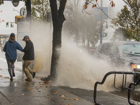 A drain is plugged at Davie and Denman after heavy rain in Vancouver, BC, Oct. 25, 2018.