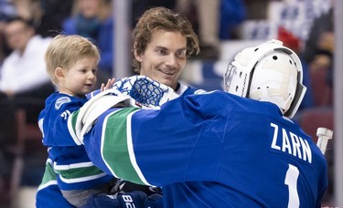 Loui Eriksson #21 of the Vancouver Canucks and his son Lou give goalie and Assistant Athletic Therapist Dave Zarn a high five during the Vancouver Canucks Super Skills Contest at Rogers Arena in Vancouver, BC, December, 2, 2018.