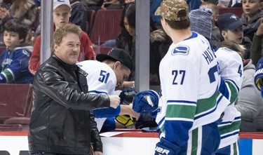 Lochlyn Munro of Riverdale is congratulated by Ben Hutton #27 of the Vancouver Canucks after scoring a goal during the Vancouver Canucks Super Skills Contest at Rogers Arena in Vancouver, BC, December, 2, 2018.