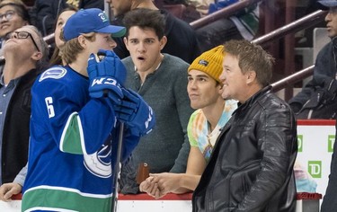 Brock Boeser #6 of the Vancouver Canucks (left) talks with members of the cast from the TV show Riverdale (from right) Lochlyn Munro, K.J. Apa and Casey Cott during the Vancouver Canucks Super Skills Contest at Rogers Arena in Vancouver, BC, December, 2, 2018.