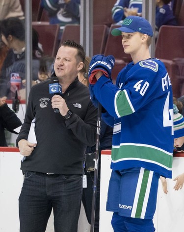 Elias Pettersson #40 of the Vancouver Canucks talks with Joey Kenward after winning the hardest shot contest during the Vancouver Canucks Super Skills Contest at Rogers Arena in Vancouver, BC, December, 2, 2018.