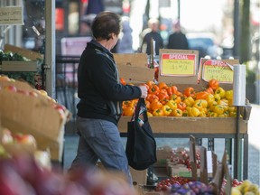 People shop for groceries on Commercial Dr. in Vancouver.