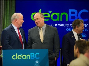 Premier John Horgan and Green party leader Andrew Weaver at the Vancouver Public Library on Dec. 5. Horgan and others announced the next details of their climate plan to reduce greenhouse gas emissions.