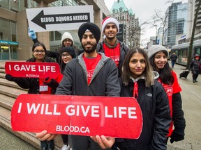 Joban Bal, front-centre, and volunteers recruit for blood donors at Burrard and Dunsmuir streets in Vancouver on Dec. 27, 2017. This week in particular Canada Blood Services runs low on stores of donated blood, something Bal and his friends would like to make you aware of.