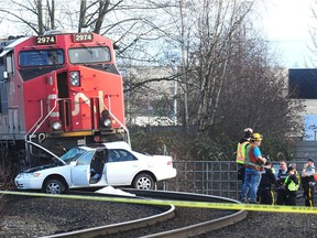 RCMP and CP investigators on scene on the tracks where an elderly couple died after a train hit their car in Langley, BC., December 30, 2018. The crash happened on the Langley Bypass near Glover Road. RCMP confirm it was an elderly couple and police do not know why the car was on the tracks.