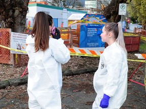 Clean up crew in action as the B.C. Coroners Service investigates after a man in his mid-30s who was stuck in a clothing donation bin and was pronounced dead at Ambleside Park in West Vancouver, BC., December 31, 2018. Police say the man was found by a passerby Sunday morning.