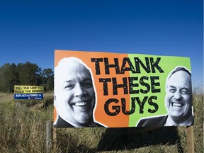 Signs erected by Liberal MLA Ian Paton beside the northbound approach to the Massey Tunnel in Delta in October 2017 blame NDP Premier John Horgan and Green party Leader Andrew Weaver for inaction on the tunnel bottleneck.