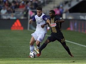 Orlando City's Victor Giro, left, and Raymon Gaddis are seen in action during an MLS soccer match, Sunday, Oct. 22, 2017, in Chester, Pa. Defender Giro was acquired by the Vancouver Whitecaps on Sunday, sending a natural third round pick in the 2019 MLS SuperDraft to Orlando City SC in return.