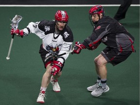 Vancouver Stealth defender Justin Salt (right) pressures Calgary Roughnecks forward Curtis Dickson during a National Lacrosse League game at the Langley Events Centre in January 2017.