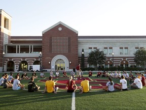 In this Sept. 5, 2013 photo, student athletes gather for a workout in front of the John McKay Center, an athletic facility on the University of Southern California campus in Los Angeles. (AP Photo/Jae C. Hong)